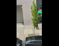 Guy runs down sidewalk after spinning in helmet 