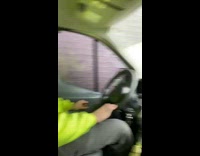 Guy in yellow safety jacket in car fast food drive thru