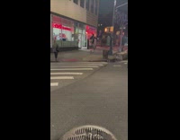 Man Rides Old Style Bike next to Pharmacy 