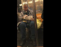 Man eats bag of french fries on subway
