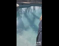 Girl steps into frozen swimming pool, breaks ice and falls into water