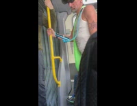 Man wears blue cell phone holder around neck on subway train