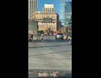Man holds at truck while riding bike