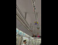 Heart shaped decorations hang on subway train handrails