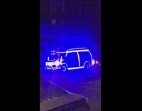 Neon LED light up van driving down the street at night