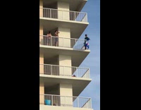 Green shirt black hat guy balcony