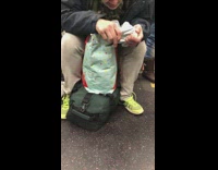 Collab Subway Creatures - man taking off clothing security tag 