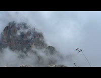 Time lapse rock mountain engulfed by clouds