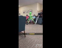 Green alien dance on sleeping man 