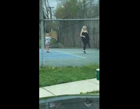 Woman black tank top walk away kids film her