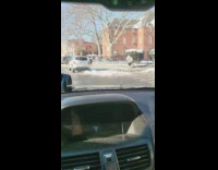 Guy running on sidewalk after a snowstorm in sweater and shorts