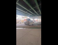 Truck turns on stoplight hits the gutter