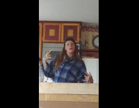 girl blue shirt throwing peace sign out and singing