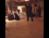 Guy long hair black dress clothes red tie dancing to Rihanna