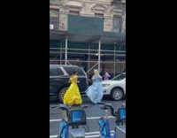 three women in disney princess dresses in street