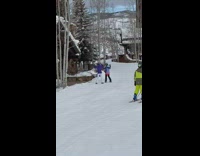 Two girls blue jacket dance ski resort