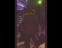 Drunk guy in sailor hat dances on white chairs at wedding party and falls off