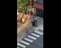 Girl in pink dress poses in street