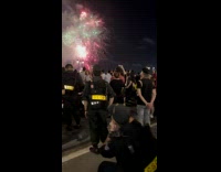 Two policemen takes picture with the fireworks