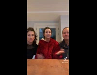 Girl records a video with her parents 