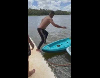 Guy jumps onto kayak but falls into water 
