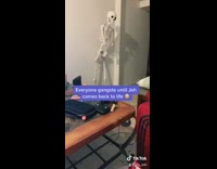 Skeleton wood chair green cushion red pants