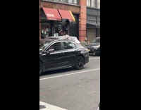 Man ride citi bike balance tire on head