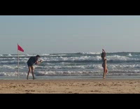 woman dance beach red flag