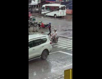 Traffic enforcer dances in the middle of the street and enforces traffic