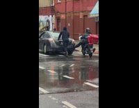 Man in Motorcycle Helps to Push Car