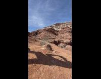 Biker bikes from tall cliff 