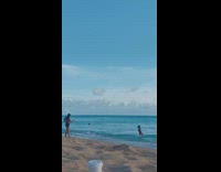 Girl black bikini stand walk towards beach