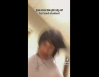 Two guys filming themselves running in hallway with wig on