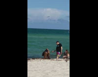 Guy film woman twerk her butt beach