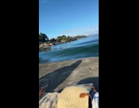Friends flooded by waves while having picnic 