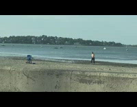 Shirtless guy dance arm movements beach chair