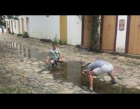 Guy summer shirt sit  ground puddle reflection