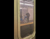 Guy on subway train platform wearing crystal mask