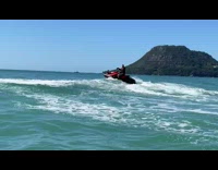 Guy ride jet ski jump over wave