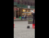 Guy performs with trumpet and buckets