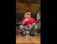 Woman grey pants large belly dance to music