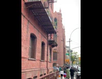Person on balcony use basket to pass out candy
