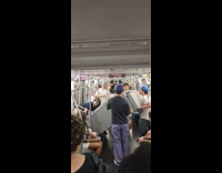 Friend group lifting couch out from subway