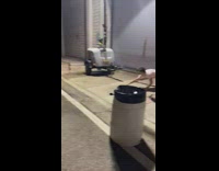 Man in white outfit stretches at the sidewalk