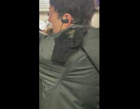 Guy has pair of underwear on shoulder on subway train