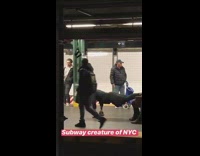 Man does push ups off bench with spinning handle at subway station