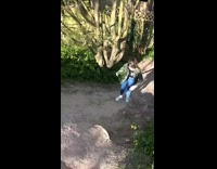 Green camouflage jacket girl slips dirt hill