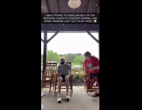 Woman photobombs video rocking chair