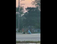 Man on ground films himself with tripod