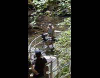 Man DJ setup equipment near the waterfalls